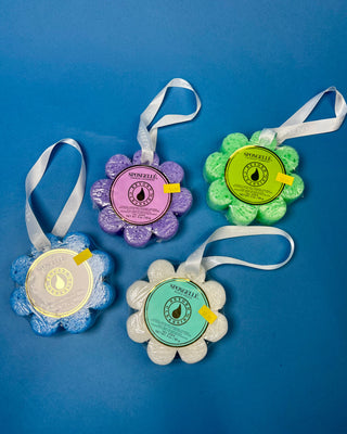 Spongellé Flower Body Wash Infused Buffer available in multiple fragrances, featuring a flower-shaped cleansing sponge infused with body wash and a convenient hanging ribbon.