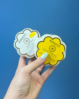 Spongellé Daisy Spongettes travel-sized body wash infused buffer available in multiple fragrances, featuring a flower-shaped cleansing sponge with gentle exfoliation and 7+ uses.
