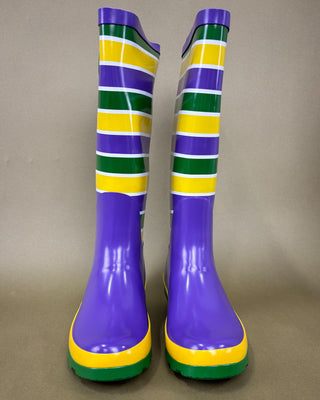 Pair of colorful striped rain boots on a beige background