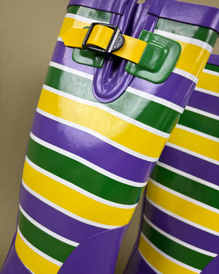 Colorful striped boots with a buckle on a plain background