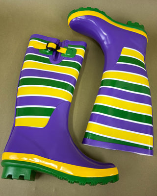 Pair of colorful striped rain boots on a beige background