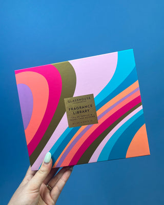 Glasshouse Fragrances Fragrance Library Discovery Set featuring eight 5mL Eau de Parfum travel sprays, a colorful presentation box, and a refillable travel case keyring for fragrance on the go.