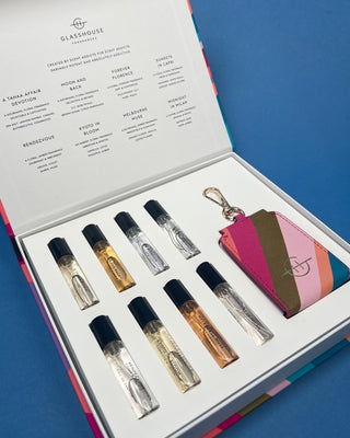 Glasshouse Fragrances Fragrance Library Discovery Set featuring eight 5mL Eau de Parfum travel sprays, a colorful presentation box, and a refillable travel case keyring for fragrance on the go.