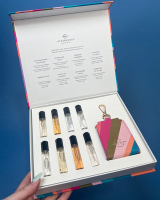 Glasshouse Fragrances Fragrance Library Discovery Set featuring eight 5mL Eau de Parfum travel sprays, a colorful presentation box, and a refillable travel case keyring for fragrance on the go.