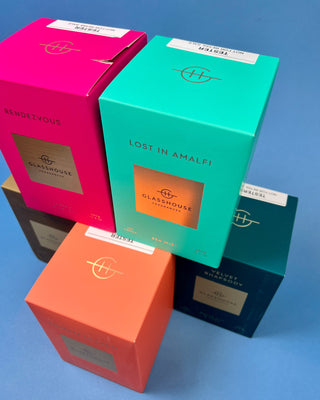 Glasshouse Fragrances 380g luxury soy candle collection featuring Lost in Amalfi, Sunsets in Capri, Kyoto in Bloom, Rendezvous, and Velvet Rhapsody candles in colorful designer gift boxes with premium glass candle vessels.