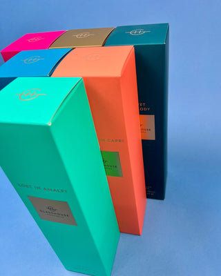 Glasshouse Fragrances 250mL reed diffuser collection featuring luxury home fragrance diffusers in Lost in Amalfi, Sunsets in Capri, Midnight in Milan, Kyoto in Bloom, Velvet Rhapsody, and Rendezvous scents with colorful signature packaging.