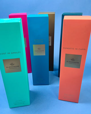 Glasshouse Fragrances 250mL reed diffuser collection featuring luxury home fragrance diffusers in Lost in Amalfi, Sunsets in Capri, Midnight in Milan, Kyoto in Bloom, Velvet Rhapsody, and Rendezvous scents with colorful signature packaging.