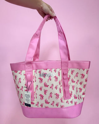 Pink tote bag with floral pattern and 'Simply' branding on a pink background