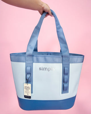 Blue and white tote bag with 'simply' branding on a pink background