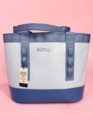 Blue and white tote bag with 'simply' branding on a pink background