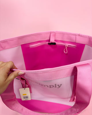 Pink bag with a visible brand tag on a pink background