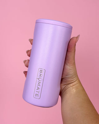 Hand holding a purple tumbler with 'BRUMATE' branding against a pink background
