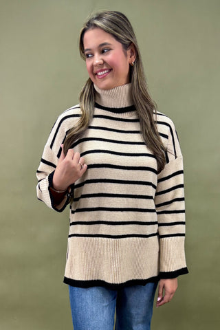 Woman wearing a striped sweater against a green background