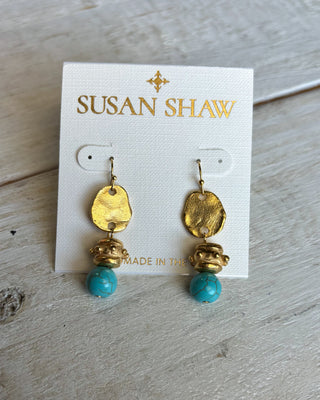 Gold and turquoise earrings on a Susan Shaw branded card.