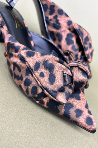Leopard print shoes with a bow on a light background