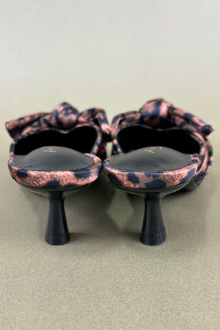 Pair of high-heeled shoes with pink and black pattern on a light gray background
