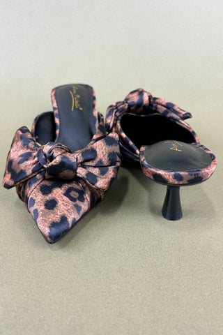 Pair of leopard print high-heeled shoes on a light gray background