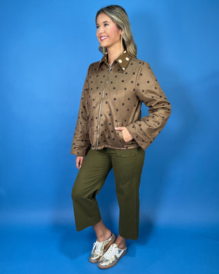 Brown polka dot zip-up jacket with a collared neckline, long sleeves, front pockets, and a relaxed fit.