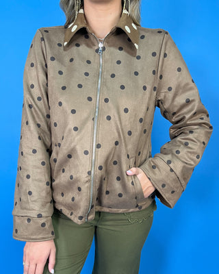 Brown polka dot zip-up jacket with a collared neckline, long sleeves, front pockets, and a relaxed fit.