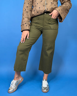 Olive green high-rise cropped wide leg pants with scalloped front patch pockets and a flattering structured fit.