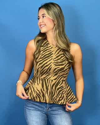 A woman modeling a sleeveless camel-brown and black zebra-print peplum top
