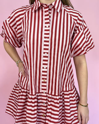 Red and white striped dress on a pink background