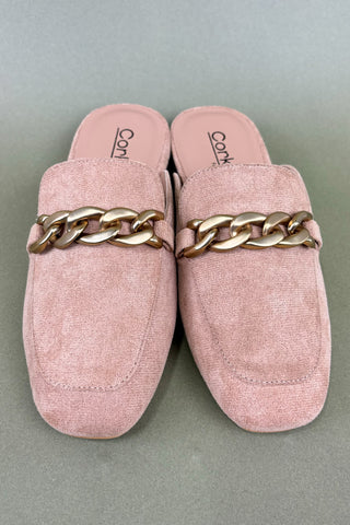 Pink loafers with gold chain details on a gray background