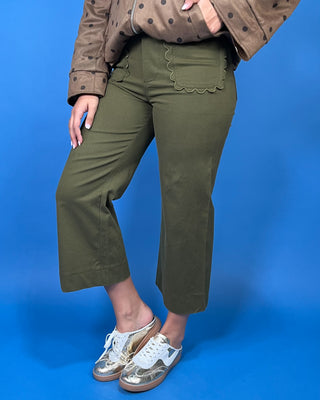 Olive green high-rise cropped wide leg pants with scalloped front patch pockets and a flattering structured fit.