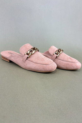 Pair of pink suede slippers with gold chain details on a light gray background