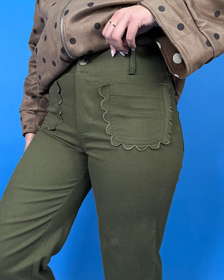 Olive green high-rise cropped wide leg pants with scalloped front patch pockets and a flattering structured fit.