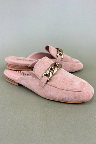 Pink suede loafers with gold chain detail on a light gray background