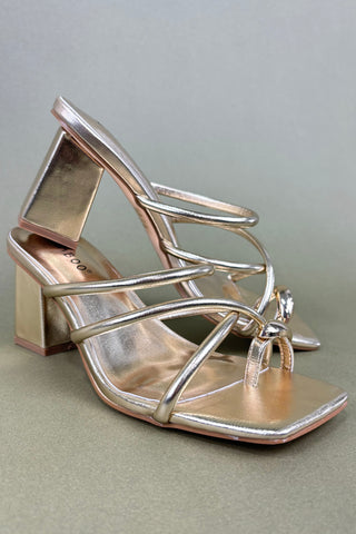 Silver high-heeled sandal on a light gray background