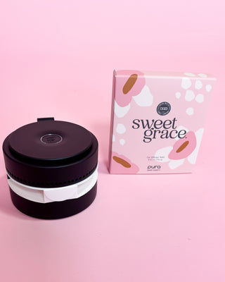 Black and white container with a pink 'sweet grace' box on a pink background