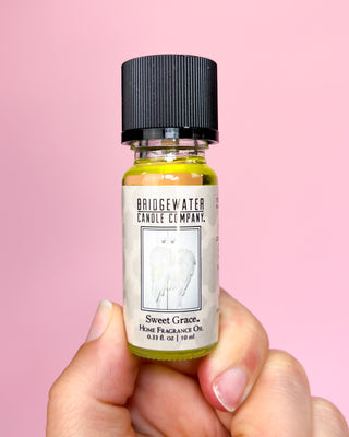 Bottle of Bridgewater Candle Company Sweet Grace home fragrance oil against a pink background