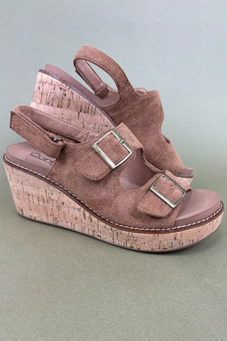Pink wedge sandal with cork sole on a light gray background