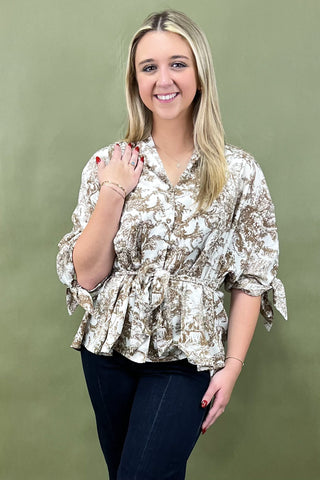 Woman wearing a floral blouse against a green background