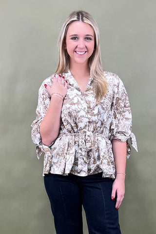 Woman wearing a floral blouse against a green background