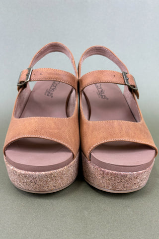 Pair of brown sandals with cork sole on a gray background