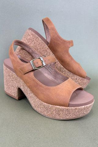 Pair of brown cork platform sandals on a gray background