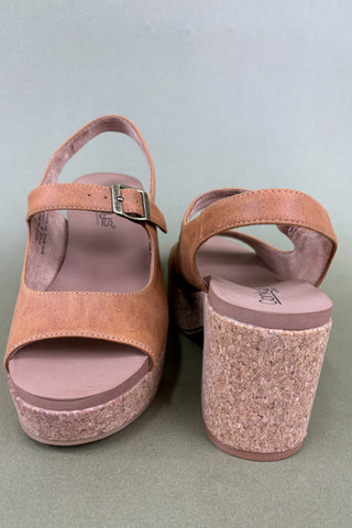 Pair of brown cork sandals on a light gray background