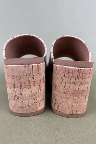 Pair of pink cork slippers on a gray background