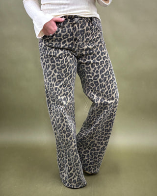 Leopard print pants worn by a person on a plain background