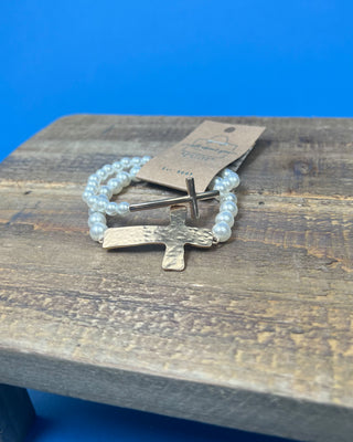 Two-piece gold cross and faux pearl stretch bracelet set featuring hammered and polished gold cross accents on white pearl bead bracelets.