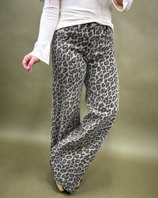 Leopard print pants worn by a person on a plain background