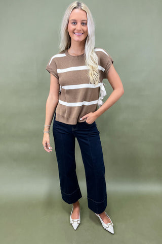 Brown and white striped knit top with side bow details styled with dark wide leg cropped jeans and white pointed loafers