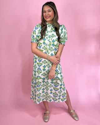 Woman wearing a floral dress against a pink background