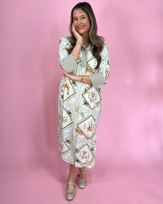 Woman wearing a floral dress with a pink background