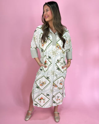 Woman wearing a patterned dress against a pink background