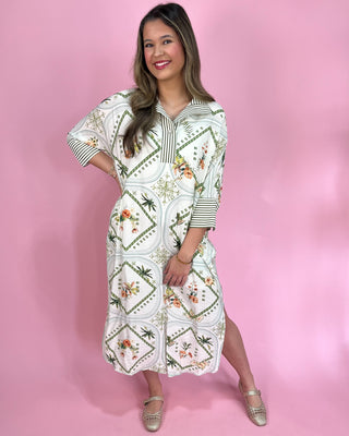 Woman wearing a white dress with floral patterns on a pink background