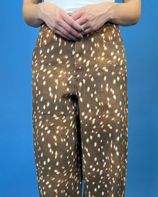 A person wearing brown pants with a white spotted deer-print pattern